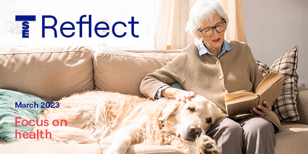 TSE Reflect - focus on health, senior woman at home reading with dog