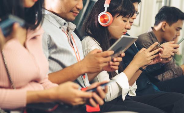 People checking there phones in a tube